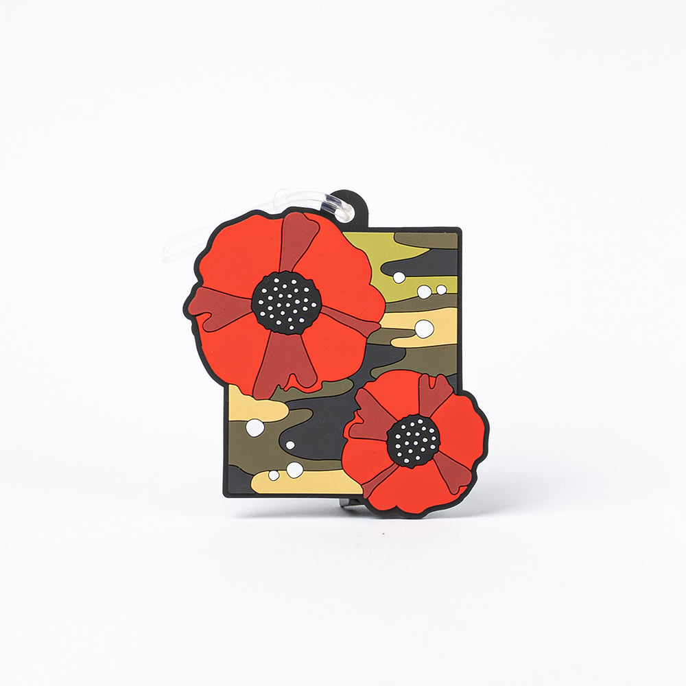 A luggage tag featuring two poppies against a green camouflage background