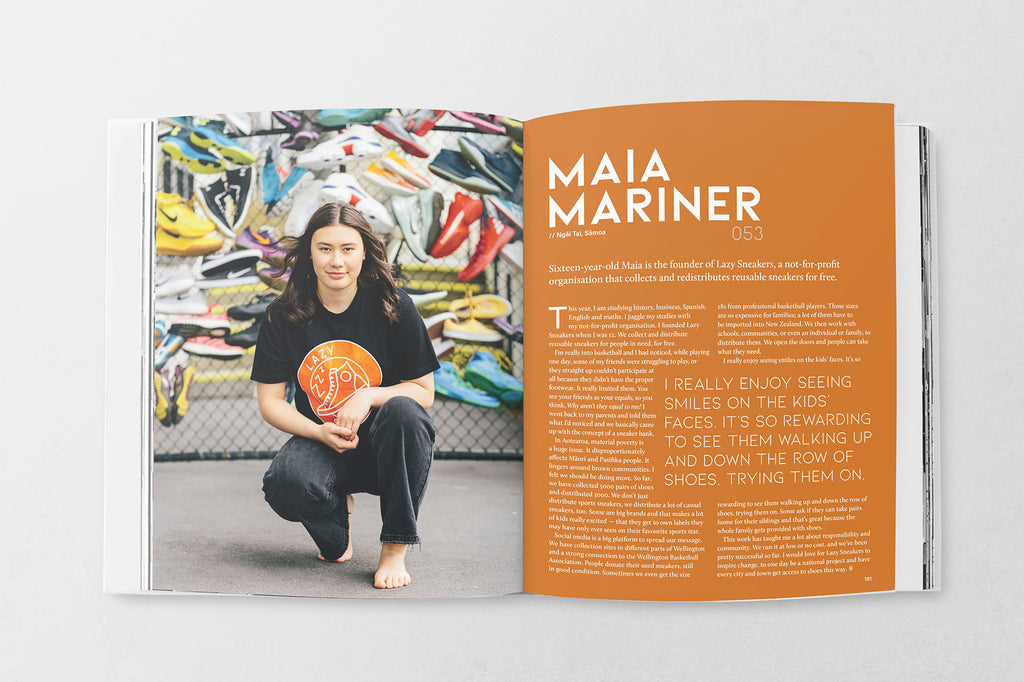 Two page spread from within the book featuring a page of text and a photograph of a young woman crouched in front of a wire fence hung with brightly coloured trainers