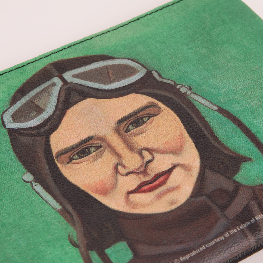 A close-up of a clutch bag featuring the Rita Angus artwork 'Aviatrix'